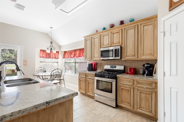 kitchen featuring sink, decorative light fixtures, backsplash, stainless steel appliances, and vaulted ceiling