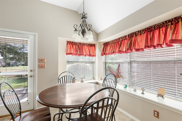 dining room featuring an inviting chandelier, vaulted ceiling, and tile patterned floors