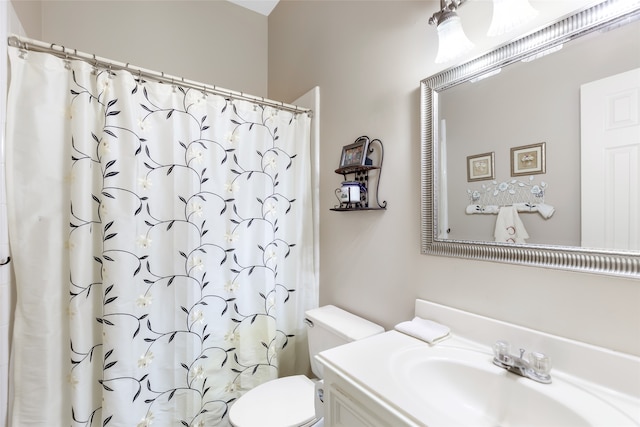 bathroom with curtained shower, vanity, and toilet