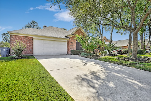 view of front of house featuring a front lawn and a garage