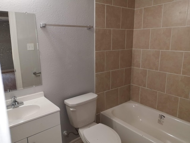 full bathroom with tiled shower / bath combo, vanity, and toilet