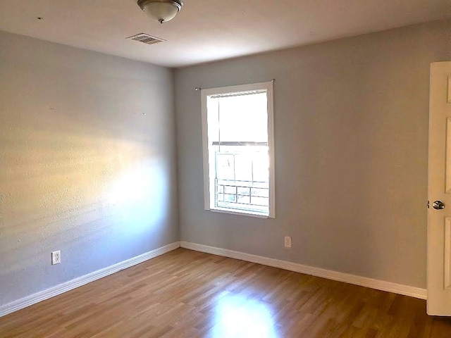 spare room with hardwood / wood-style floors