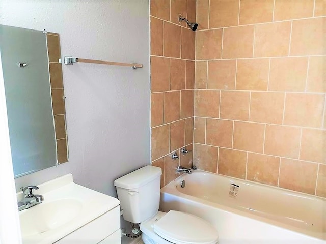 full bathroom with tiled shower / bath combo, vanity, and toilet