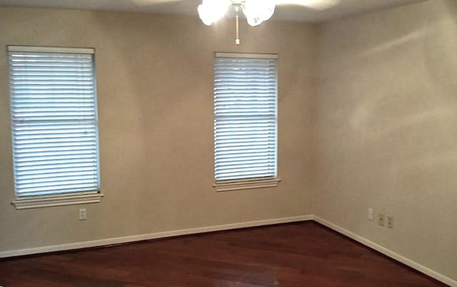 spare room with ceiling fan and dark hardwood / wood-style floors