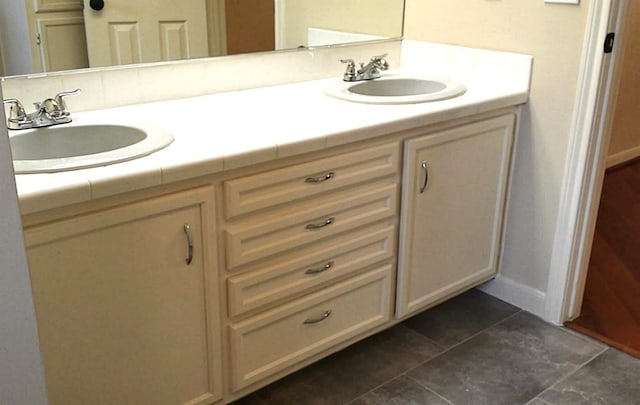 bathroom featuring tile patterned flooring and vanity