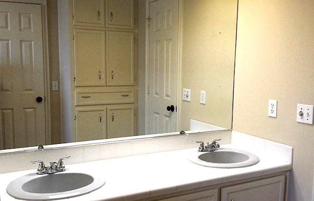 bathroom with vanity and tasteful backsplash