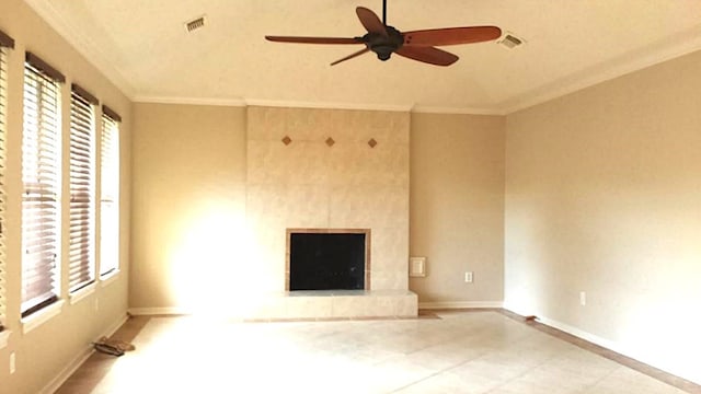 unfurnished living room with ornamental molding, plenty of natural light, and a tile fireplace