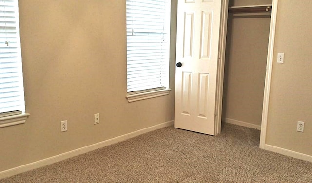 unfurnished bedroom featuring carpet floors and a closet