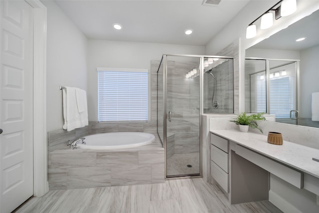 bathroom with separate shower and tub and vanity