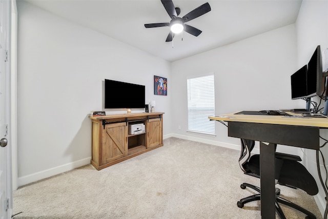 office space featuring light carpet and ceiling fan