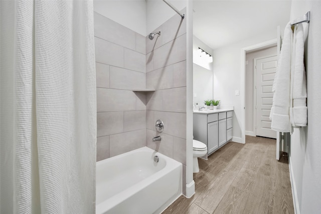 full bathroom featuring hardwood / wood-style floors, toilet, vanity, and shower / bathtub combination with curtain