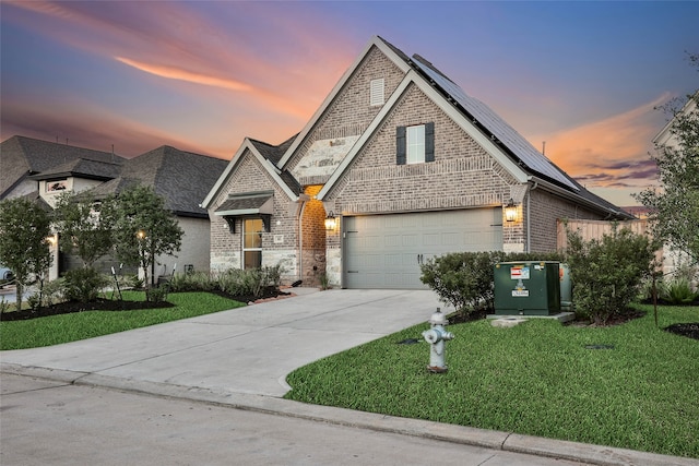 view of front of house featuring a garage and a lawn