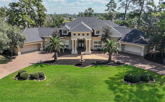 view of front facade featuring a front yard and a garage