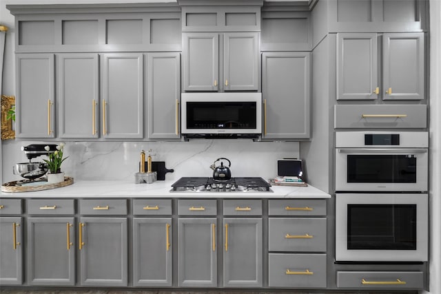 kitchen featuring gray cabinets and white appliances