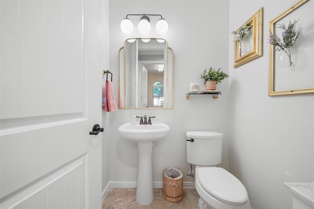 226 Hampton Glen Rd, Montgomery, TX 77356 - half bath with tile patterned floors, baseboards, a sink, and toilet