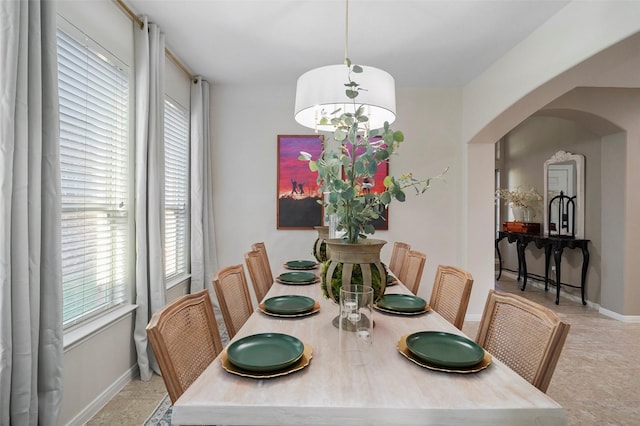 226 Hampton Glen Rd, Montgomery, TX 77356 - dining area with arched walkways, a healthy amount of sunlight, baseboards, and a notable chandelier