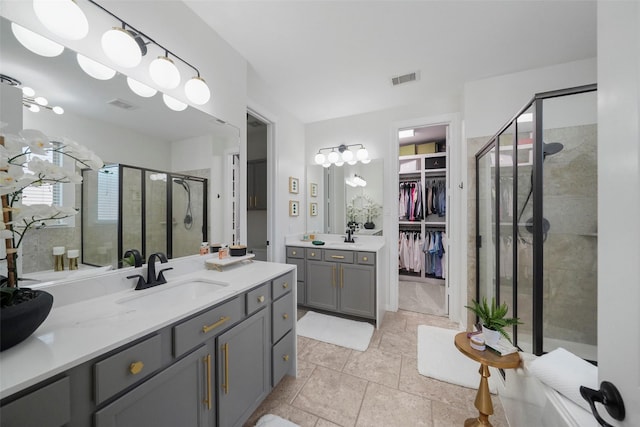 226 Hampton Glen Rd, Montgomery, TX 77356 - bathroom featuring a sink, two vanities, a stall shower, visible vents, and a spacious closet