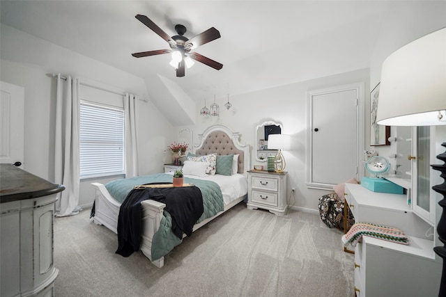 bedroom with lofted ceiling, light colored carpet, and ceiling fan