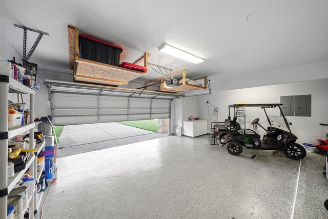 garage with a garage door opener and electric panel