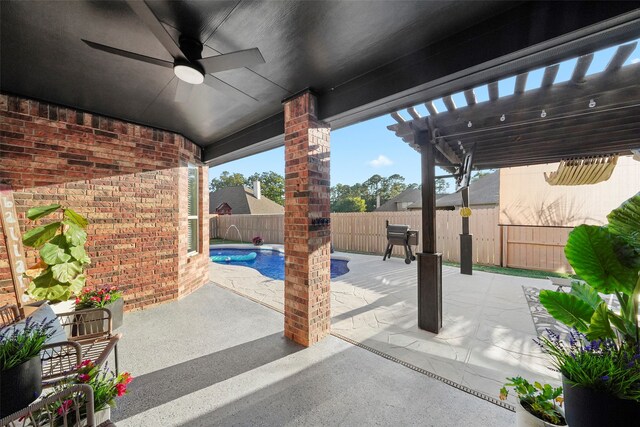 view of patio / terrace with pool water feature, ceiling fan, a pergola, and a fenced in pool