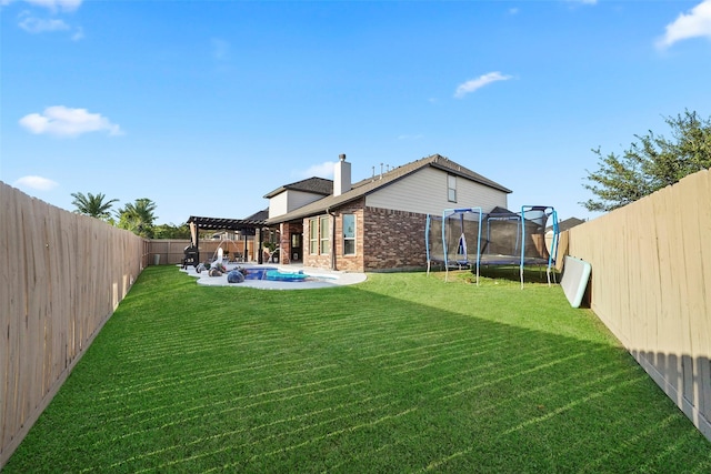 226 Hampton Glen Rd, Montgomery, TX 77356 - rear view of property with a fenced backyard, a pergola, a chimney, brick siding, and a trampoline