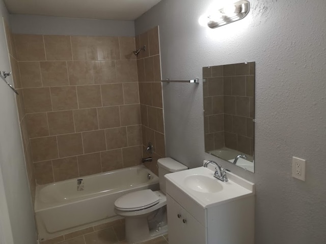 full bathroom with vanity, tiled shower / bath combo, toilet, and tile patterned flooring