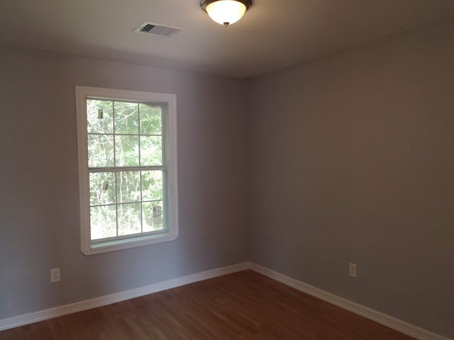 spare room with hardwood / wood-style flooring