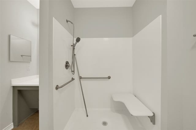 bathroom with walk in shower and tile patterned flooring