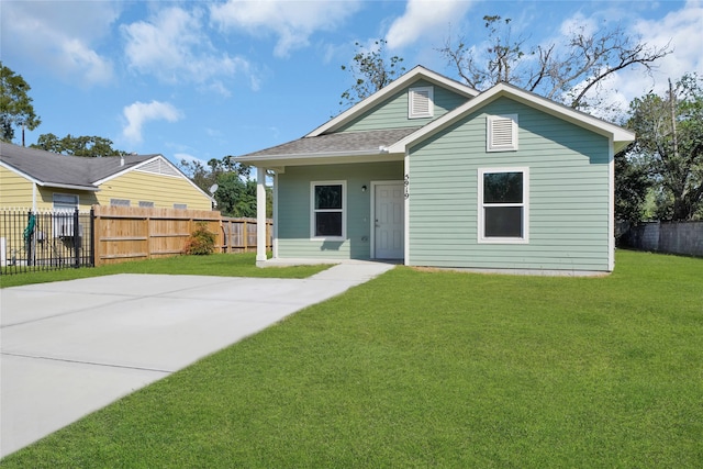 rear view of house featuring a yard