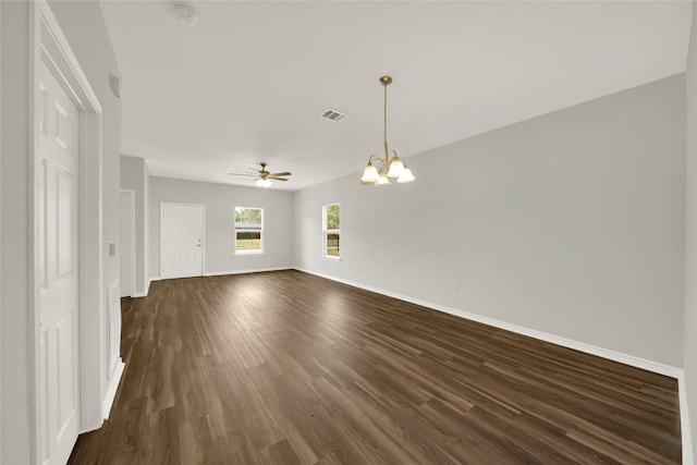 empty room featuring ceiling fan with notable chandelier and dark wood-type flooring