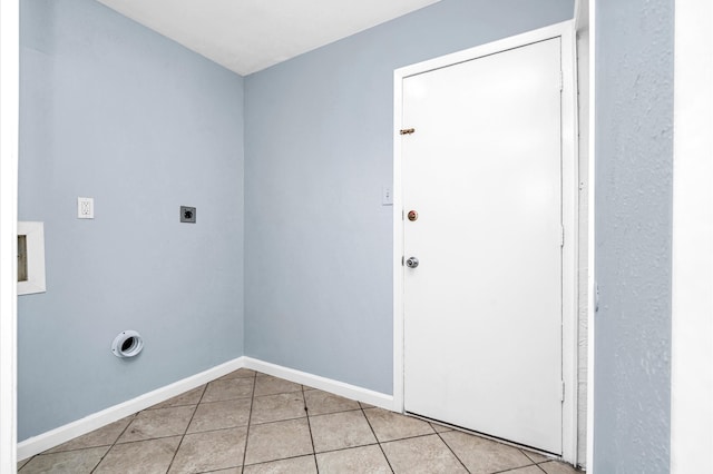 washroom featuring hookup for an electric dryer and light tile patterned floors