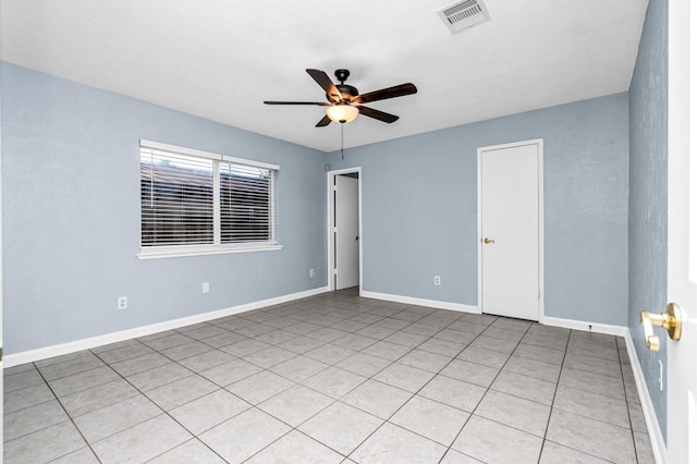 empty room with light tile patterned floors and ceiling fan