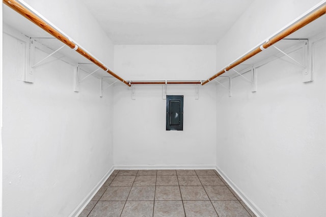 spacious closet featuring electric panel and light tile patterned floors