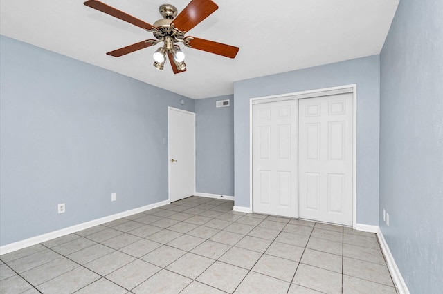 unfurnished bedroom with ceiling fan, a closet, and light tile patterned floors