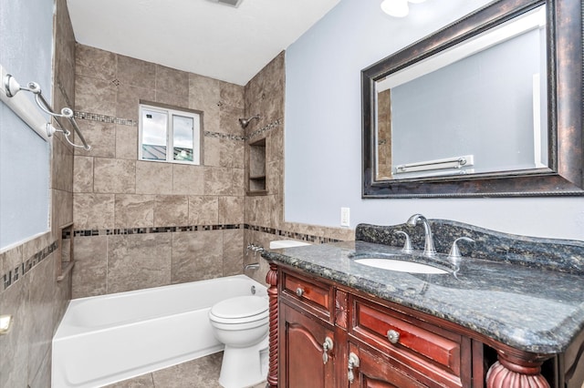 full bathroom featuring toilet, tile walls, vanity, and tiled shower / bath combo