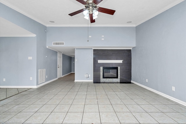 unfurnished living room featuring ceiling fan, light tile patterned floors, a tiled fireplace, and ornamental molding