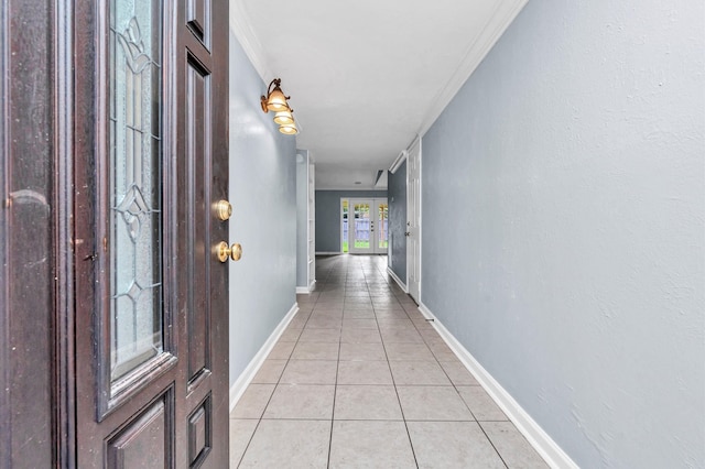 corridor featuring ornamental molding, french doors, and light tile patterned floors