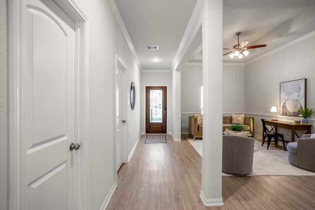 entrance foyer with crown molding, light wood-type flooring, and ceiling fan