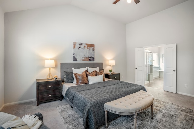 bedroom featuring ensuite bath, high vaulted ceiling, ceiling fan, and light colored carpet