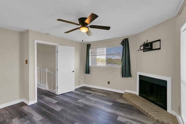 unfurnished living room with dark hardwood / wood-style floors, a fireplace, and ceiling fan