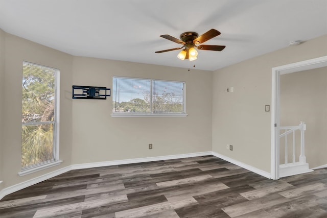 empty room with dark wood-type flooring and ceiling fan