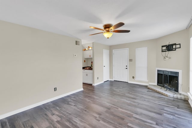 unfurnished living room featuring wood-type flooring and ceiling fan