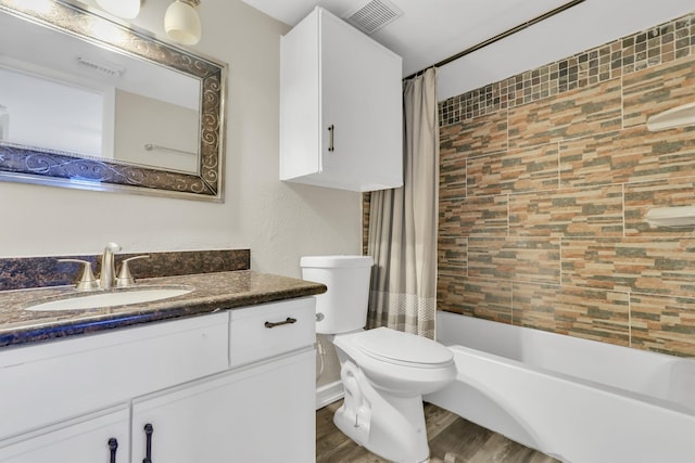 full bathroom featuring vanity, toilet, hardwood / wood-style flooring, and shower / tub combo with curtain