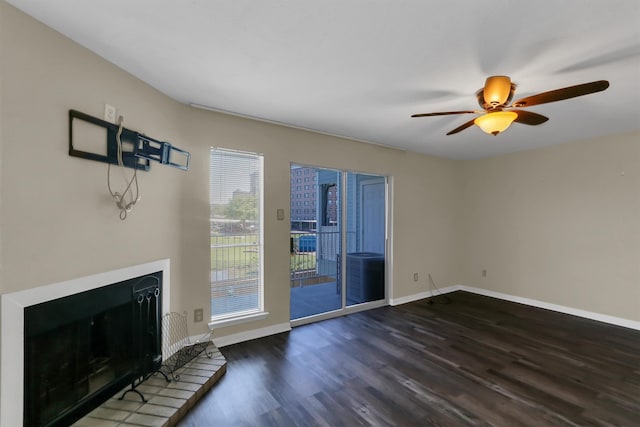 unfurnished living room featuring dark hardwood / wood-style floors and ceiling fan