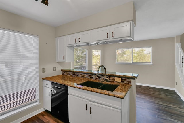 kitchen featuring black dishwasher, white cabinetry, dark stone counters, dark wood-type flooring, and sink