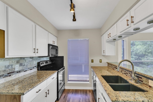 kitchen with light stone counters, stainless steel range with electric stovetop, sink, and white cabinets