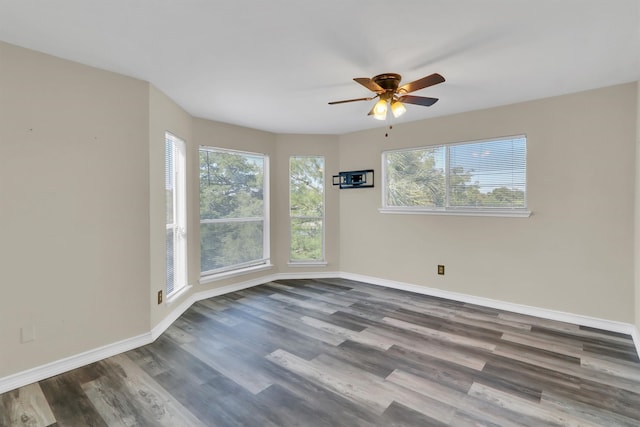 unfurnished room with ceiling fan and dark hardwood / wood-style flooring