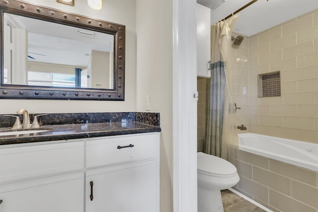 full bathroom featuring toilet, vanity, and shower / bathtub combination with curtain