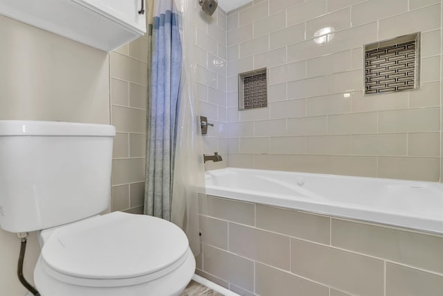 bathroom with shower / tub combo with curtain and toilet