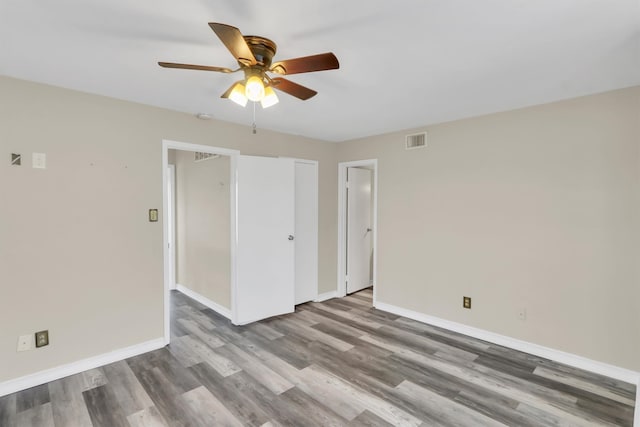 unfurnished room with hardwood / wood-style flooring and ceiling fan